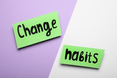 Paper notes with phrase Change Habits on color background, flat lay