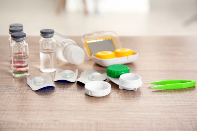 Contact lenses and accessories on wooden table