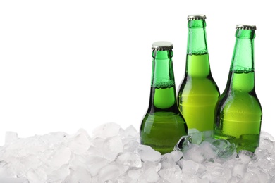 Photo of Bottles of beer on ice cubes against white background