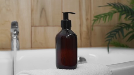 Bottle of bubble bath on tub indoors