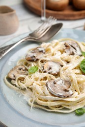 Photo of Delicious pasta with mushrooms and cheese on table, closeup