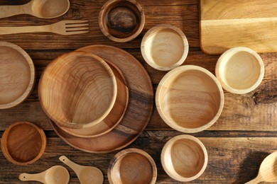 Photo of Many different wooden dishware and utensils on table, flat lay
