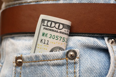 Dollar banknote in pocket of jeans, closeup. Spending money