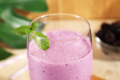 Delicious blackberry smoothie with mint in glass, closeup