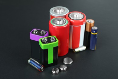 Image of Different types of batteries on black background
