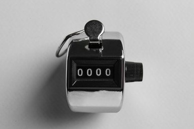 Modern timer on light grey background, top view