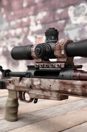Closeup view of modern powerful sniper rifle with telescopic sight outdoors