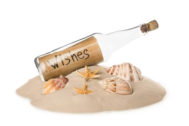 Corked glass bottle with Wishes note and seashells on sand against white background