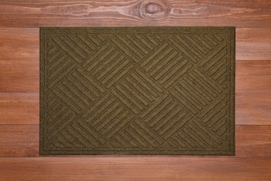 New clean door mat on wooden floor, top view