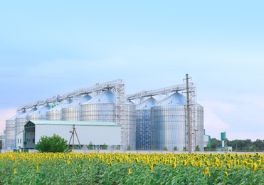 Photo of Row of modern granaries for storing cereal grains in field