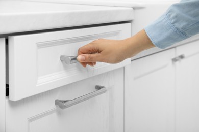 Photo of Woman opening drawer at home, closeup view