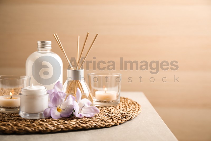 Composition with skin care products and reed air freshener on grey table, space for text