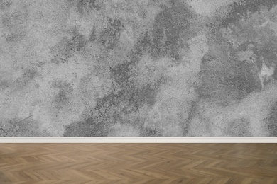 Image of Wooden floor and empty grey wall indoors