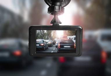 Modern dashboard camera mounted in car, view of road during driving