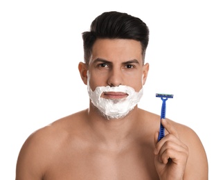Handsome man shaving with razor on white background