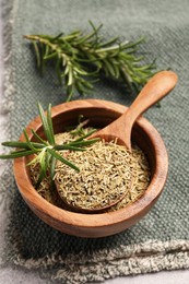 Photo of Fresh and dry rosemary on towel, above view