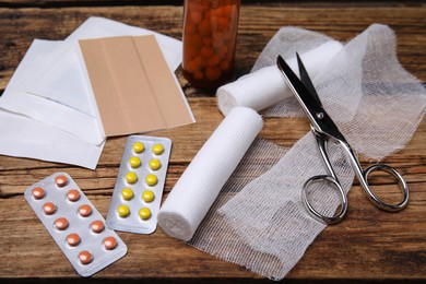 White bandage rolls and medical supplies on wooden table