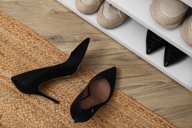 Stylish female shoes on floor in hall, top view