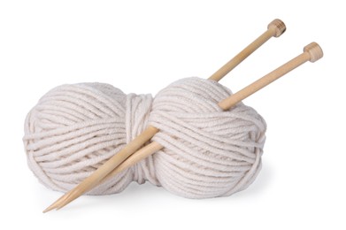 Soft woolen yarn and knitting needles on white background