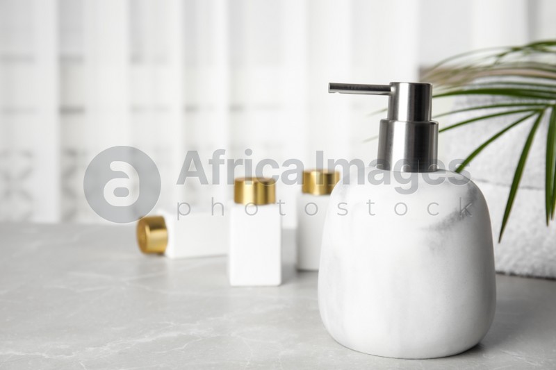 Modern marble soap dispenser on light table