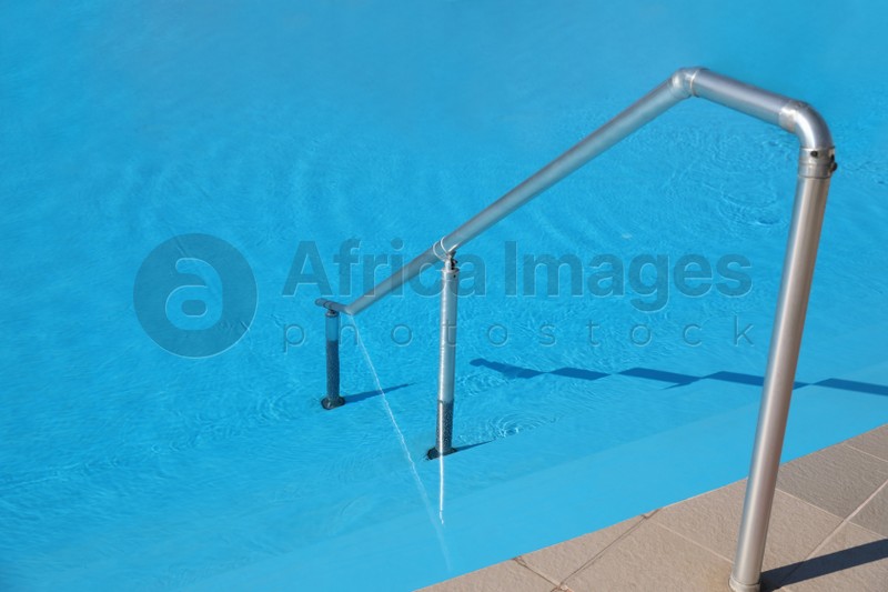 Photo of Modern swimming pool with step ladder. Summer vacation