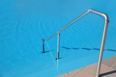 Modern swimming pool with step ladder. Summer vacation