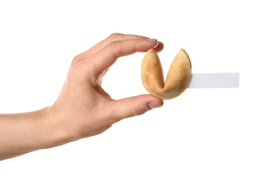 Woman holding traditional fortune cookie with prediction on white background, closeup