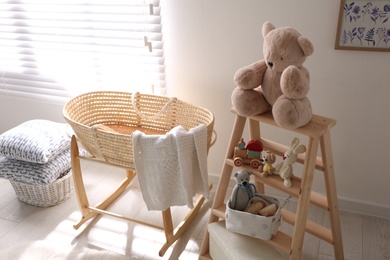 Decorative ladder with toys and different stuff in stylish baby room. Idea for interior design
