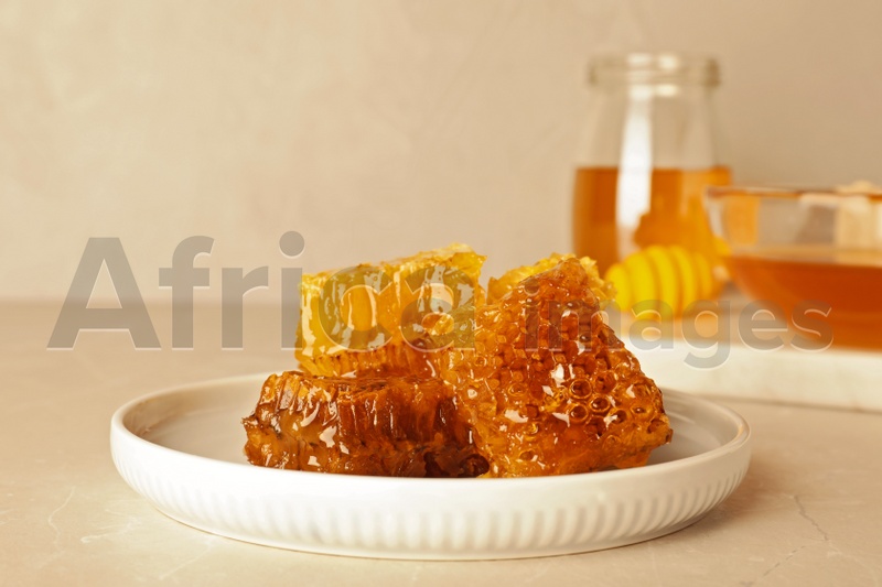 Photo of Plate with fresh sweet honeycombs on table