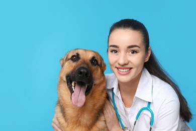 Veterinarian doc with dog on color background