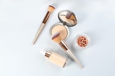 Flat lay composition with makeup brushes on light background