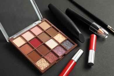 Photo of Set of makeup products on dark background