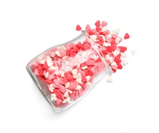 Jar and scattered candy hearts on white background, top view