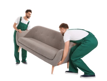 Young workers lifting sofa isolated on white. Moving service