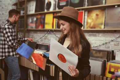 Young woman with vinyl records in store