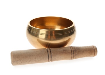 Golden singing bowl and mallet on white background.  Sound healing