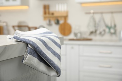 Clean towel on white marble countertop in kitchen. Space for text
