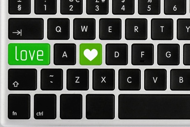 Love buttons on laptop keyboard, top view. Online dating site