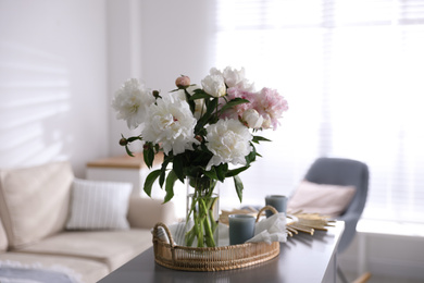 Bouquet of beautiful peony flowers on table indoors