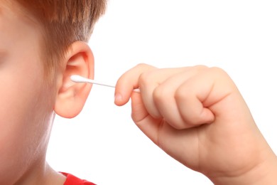 Little boy cleaning ear with cotton swab on white background, closeup