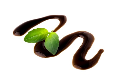 Photo of Balsamic glaze and basil leaves on white background