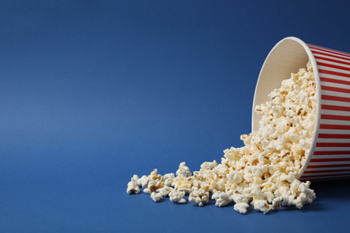 Delicious popcorn on blue background. Space for text