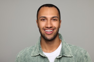 Photo of Portrait of smiling African American man on light grey background