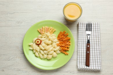 Tasty pasta served with juice on wooden table, flat lay. Creative idea for kid lunch