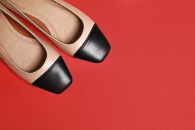 Photo of Pair of new stylish square toe ballet flats on red background, flat lay. Space for text