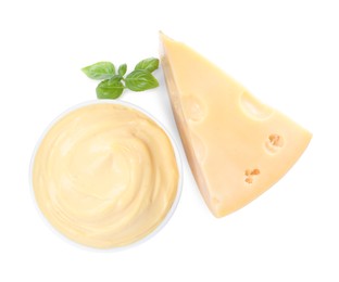 Tasty cheese, sauce and basil on white background, top view