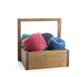 Wooden basket with clews of colorful knitting threads on white background