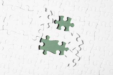 Blank white puzzle with separated pieces on grey background, flat lay