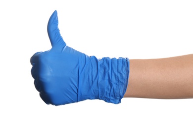 Woman in blue latex gloves showing thumb up gesture on white background, closeup of hand