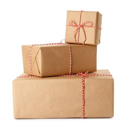 Gift boxes wrapped in kraft paper with bows on white background